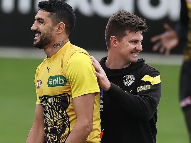 MELBOURNE - June 15 , 2023  : AFL. Richmond training.   Richmonds Marlion Pickett gets a pat on the back from Richmond caretaker coach Andrew McQualter during the Tigers training session at Punt Road Oval today  . Photo by Michael Klein.