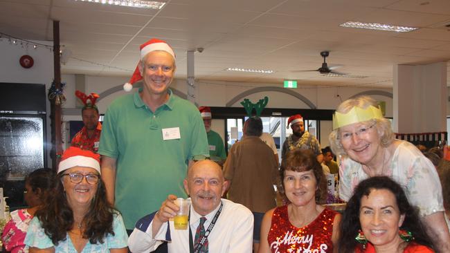 Enjoying the meal at the 2022 Cairns Community Christmas Lunch were L-R Kerry Smith, Glen Duncan (green shirt), Michael Foster, Ellen Woff, Rosemary Burgess (in white) and Theresa Boon. Picture: Alison Paterson