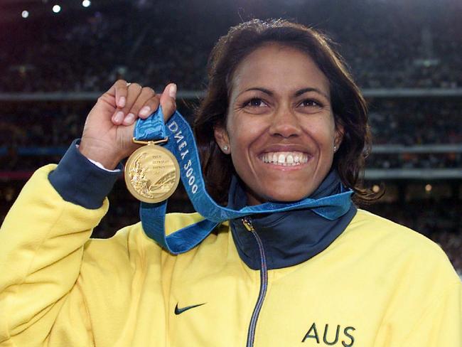 SEPTEMBER 25, 2000 : Athlete Cathy Freeman of Australia on podium wearing her gold medal after winning final of Women's 400 spint Sydney Olympic Games at Stadium Australia, Homebush, 25/09/00. Pic Craig Borrow. Athletics P/ Sydney2000