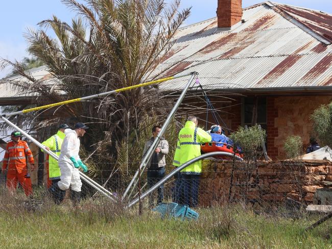 Police remove remains to be that of Robert Atkins from a water tank in the state’s mid north. Picture: Riley Walter