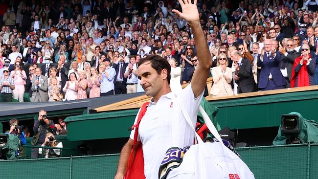 Roger Federer of Switzerland waves to the crowd after losing in 2021. Photo by Julian Finney/Getty Images.