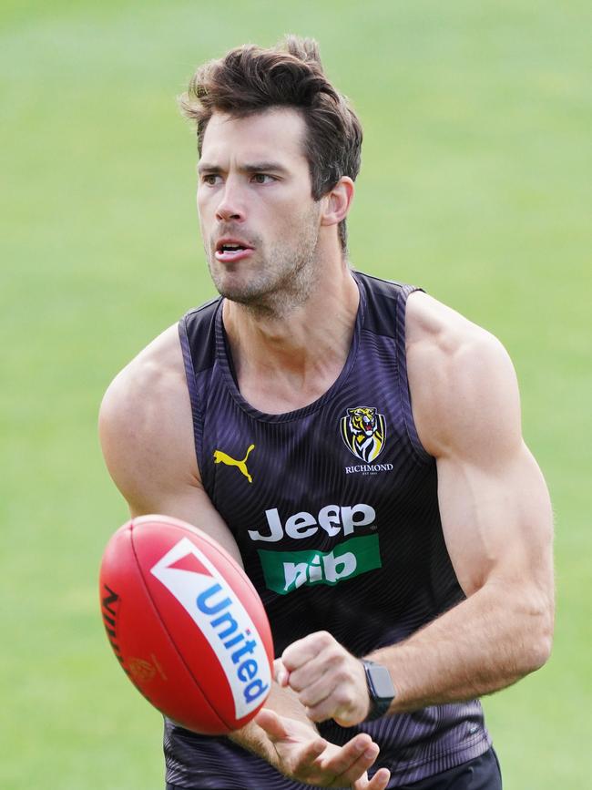 Alex Rance of the Tigers handballs during a Richmond Tigers training session at Punt Road Oval in Melbourne, Monday, December 2, 2019. (AAP Image/Michael Dodge) NO ARCHIVING