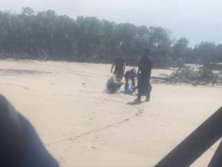 This still from video footage shows five men stranded. They appear to have been on Australian soil for several days before they were discovered.