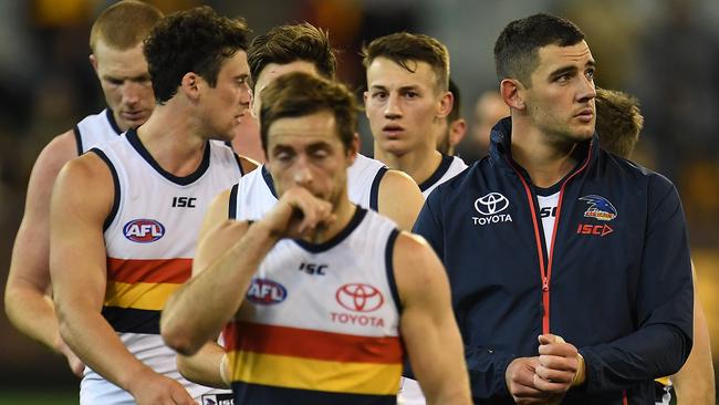 Taylor Walker of the Crows, right, leads his players from the ground after the Round 13 capitulation to Hawthorn. Picture: AAP Image/Julian Smith