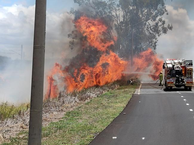 A fire that jumped Gladstone Benaraby Road at Glen Eden has shut the road to traffic. Picture: Rodney Stevens