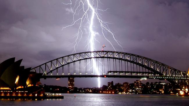 Lightning strikes over the Sydney Harbour Bridge as seen from Mrs Macquarie's Chair as storm front moves across Sydney.