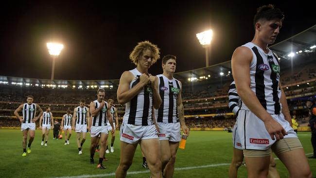Collingwood players walk off after losing to Richmond. AAP Image/Tracey Nearmy