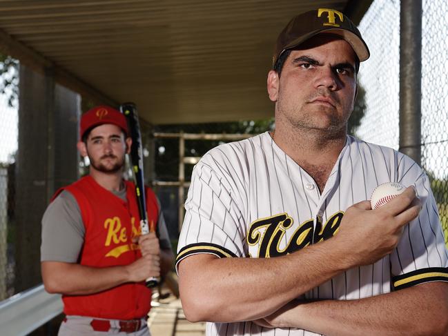 Tracy Village Rebels pitcher Cal Hooley with Nightcliff Tigers utility Kieran Bush in September, 2018. Picture: Keri Megelus.