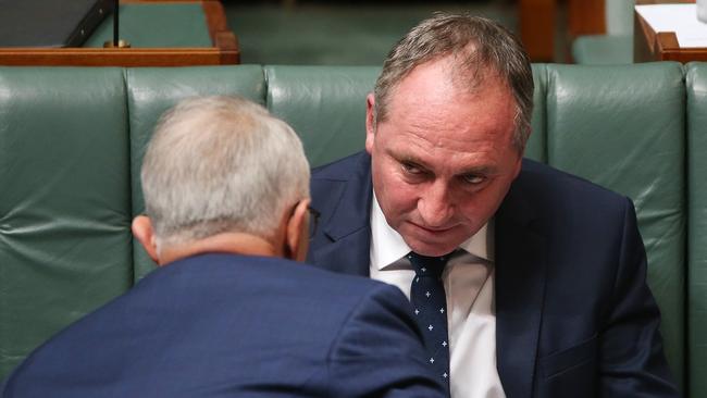 Malcolm Turnbull and Barnaby Joyce confer during Question Time. Picture Kym Smith