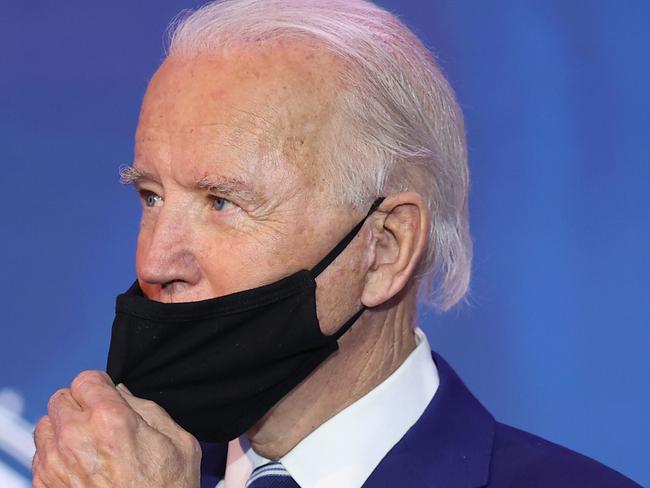 WILMINGTON, DELAWARE - DECEMBER 09: U.S. President-elect Joe Biden gives the thumbs-up as he adjusts his mask after he announced U.S. Army (retired) General Lloyd Austin as his choice to be Secretary of the Department of Defense at the Queen Theatre on December 09, 2020 in Wilmington, Delaware. The only African-American to have headed U.S. Central Command, Lloyd Austin, 67, is a four-star general who was in charge of American forces in Iraq from 2010 to late 2011.   Chip Somodevilla/Getty Images/AFP == FOR NEWSPAPERS, INTERNET, TELCOS & TELEVISION USE ONLY ==