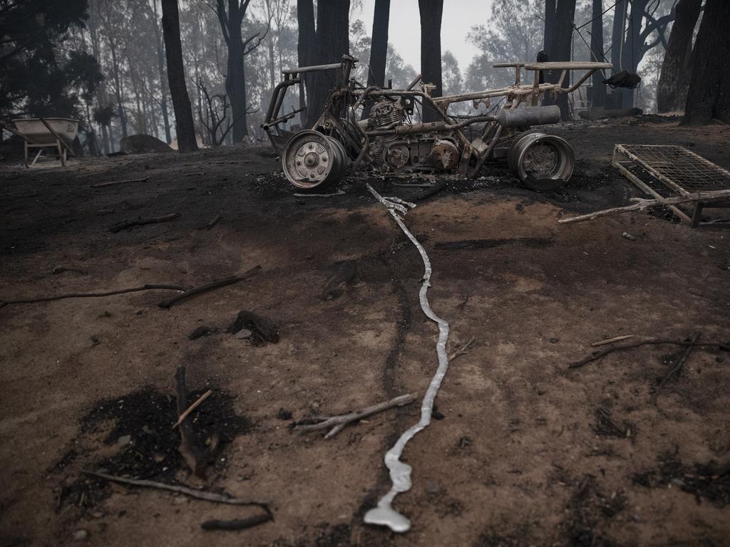 The morning after a devastating blaze destroyed homes and businesses in the small town of Cobargo. The town has been decimated by fire. A destroyed tractor in the backyard of a destroyed property. Picture Gary Ramage