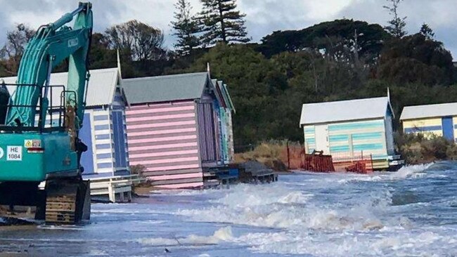 The violent seas wash against Brighton’s bathing boxes.