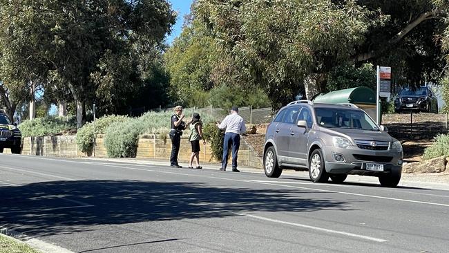 Police talk to school staff outside Bendigo South East Secondary College on Thursday.