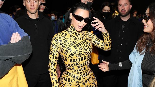 Kim Kardashian dons a yellow caution tape ensemble at the Balenciaga Fall/Winter 2022/2023 show during Paris Fashion Week at Le Bourget in Paris.