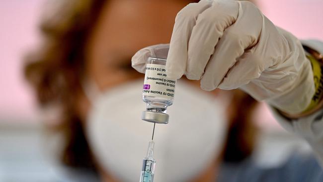 A health worker prepares a dose of the AstraZeneca/Oxford vaccine.