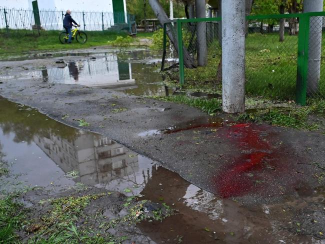 Blood is seen on a sidewalk in a residential area following shelling in Kharkiv, eastern Ukraine. Picture: AFP