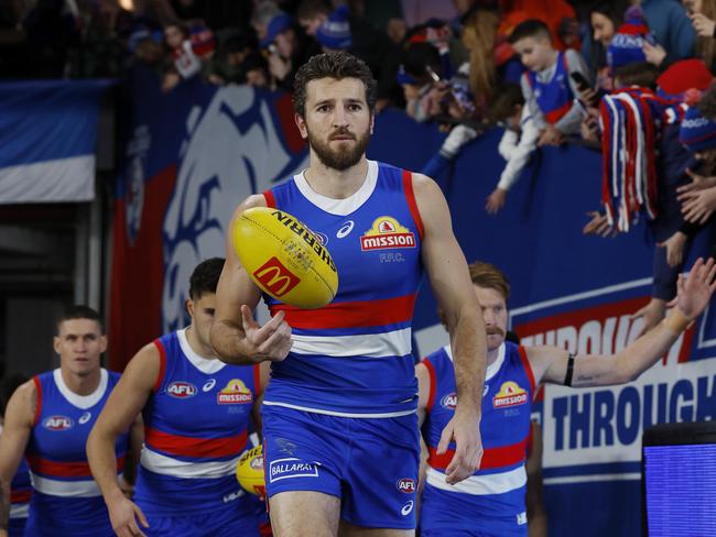 AFL Round 16. North Melbourne vs Western Bulldogs at Marvel Stadium. Bulldog skipper Marcus Bontempelli leads his team onto Marvel Stadium. Pic: Michael Klein.