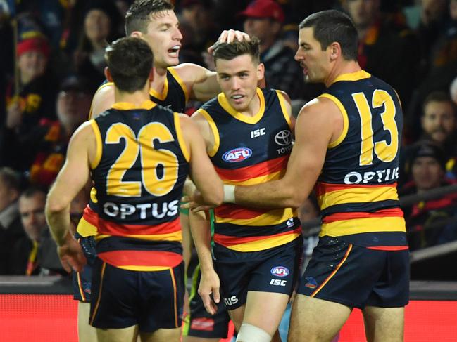 Paul Seedsman of the Crows celebrates a goal with teammates during the Round 13 AFL match between the Adelaide crows and the Richmond Tigers at the Adelaide Oval in Adelaide, Thursday, June 13, 2019.  (AAP Image/Sam Wundke) NO ARCHIVING, EDITORIAL USE ONLY