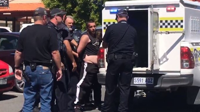 Parolee Luke Brandon is arrested at Goolwa shopping centre. Picture: Nine News