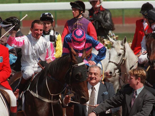 Owner Nick Moraitis leading Might And Power with jockey Jim Cassidy aboard after winning the 1997 Melbourne Cup.