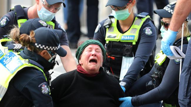 Police arrest a woman at Flinders st station after she allegedly tried to bite an officer. Picture: Alex Coppel