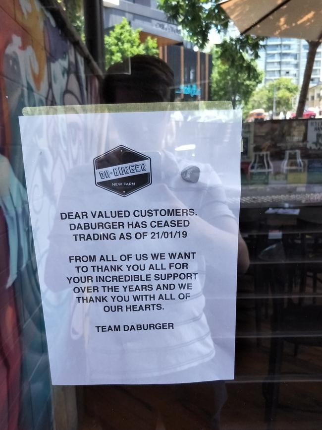 A sign on the door of DA'Burger informing customers of their closure.