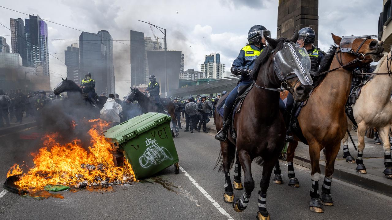 Anti-war activists protest the Land Forces 2024 International Land Defence Exposition at the Melbourne Convention and Exhibition Centre. Protesters attempt to establish a burning barricade on the Clarendon Street Bridge. Picture: Jake Nowakowski