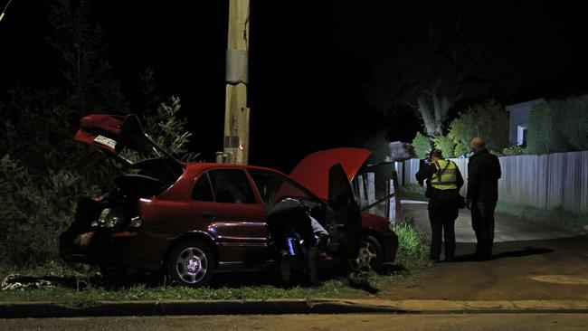 Tasmanian police inspect a  car out the front of a Magra property on Back River Road.  Picture: Zak Simmonds