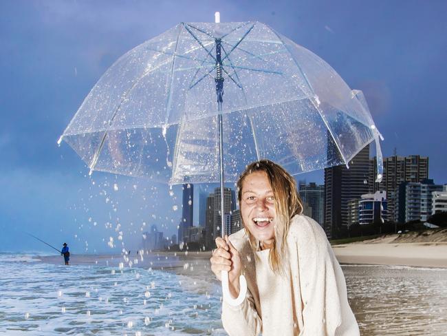 Flooding & Rain on the Gold Coast. Jess Peterson, 25 from Mermaid Beach didn’t let the rain stop her from a morning walk at Narrowneck on the Gold Coast. Photo - Nigel Hallett