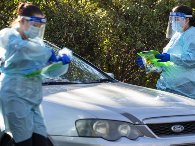 BRISBANE, AUSTRALIA - AUGUST 24: Nurses are seen doing COVID-19 testing at a drive-thru fever clinic in Ipswich on August 24, 2020 in Brisbane, Australia. A cluster of COVID-19 cases linked to Brisbane Youth Detention Centre has sparked public health alerts across Brisbane, Logan and Ipswich in southeast Queensland.  (Photo by Glenn Hunt/Getty Images)