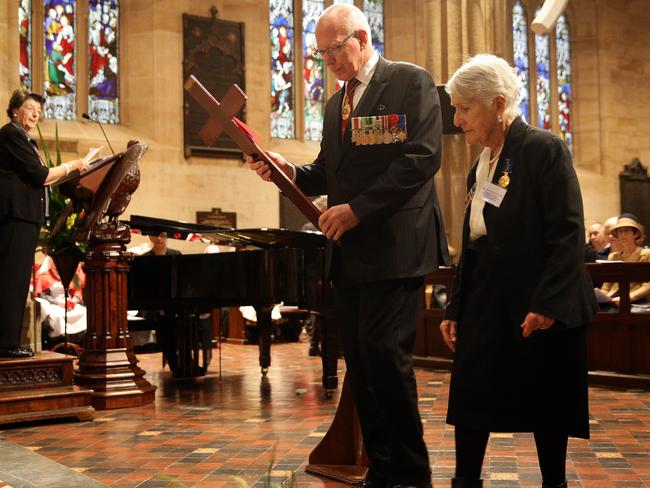 NSW Governor David Hurley lays a cross for the Unknown Warrior at the War Widows' ANZAC Field of Remembrance service at St Andrew's Cathedral. Picture: Jonathan Ng