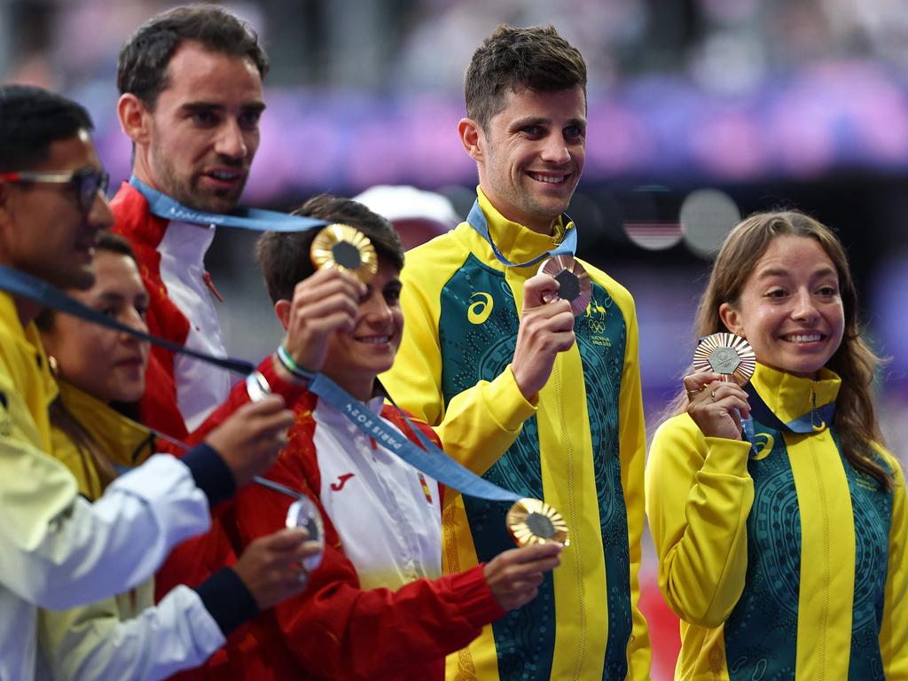 From left, silver medallists Ecuador's Brian Daniel Pintado and Glenda Morejon, gold medallists, centre, Spain's Alvaro Martin and Maria Perez, and bronze medallists, Australia's Rhydian Cowley and Jemima Montag make it official. Picture: Anne-Christine Poujoulat/AFP