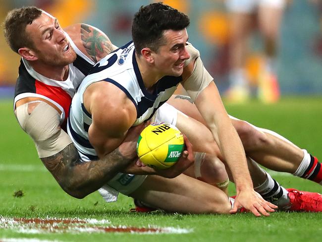 BRISBANE, AUSTRALIA - AUGUST 10: Mark O'Connor of the Cats is tackled by Tim Membrey of the Saints during the round 11 AFL match between the St Kilda Saints and the Geelong Cats at The Gabba on August 10, 2020 in Brisbane, Australia. (Photo by Jono Searle/AFL Photos/via Getty Images)