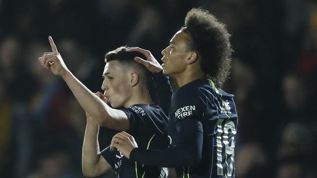 Manchester City's Phil Foden, left, celebrates with his teammate Leroy Sane after scoring his side's third goal. Picture: AP