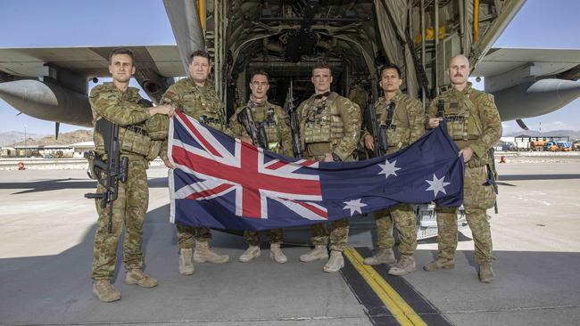 The last six remaining Australian troops with the Australian flag before boarding a RAAF C130 aircraft at the Hamid Karzai International Airport in Kabul, Afghanistan. Picture: NCA NewsWire/Gary Ramage