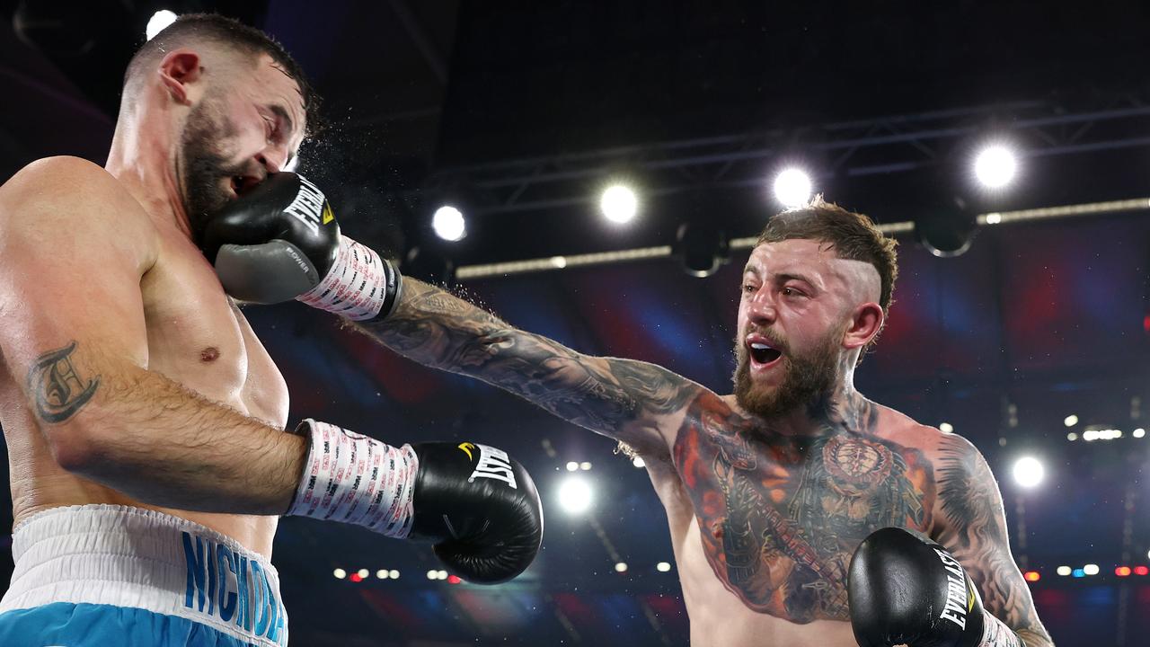 Terry Nickolas receives a punch to the face from Lachlan Higgins. Picture: Michael Klein