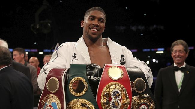 Anthony Joshua celebrates with his belts after victory over Joseph Parker.