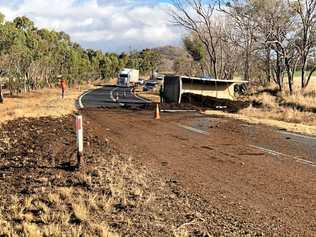 The New England Highway is blocked with manure after a truck's trailer rolled over this afternoon at Ballandean. Picture: Liana Walker