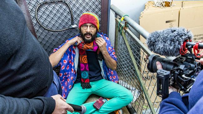 As a Greens councillor in June 2022, Jonathan Sriranganathan locked himself to a front door in Taringa to prevent the eviction of David Barker from public housing. Picture: Richard Walker