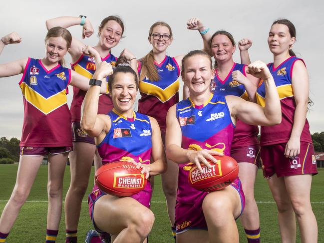 Lions AFLW players Ally Anderson and Shannon Campbell with Moreton Bay Lions juniors Jaydah Barrie 13, Chaye Barrie 15, Kirra Barrie 16, Katie Rooks 17, and Bailey Rooks 17 at the Moreton Bay Sports Complex at Burpengary where Brisbane will take on Essendon this weekend. Picture Lachie Millard