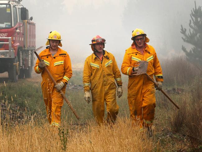 Volunteers from Whorouly CFA Nathan de Vries, Dan Taylor and Peter de Vries at the edge of a containment line. Picture: David Geraghty