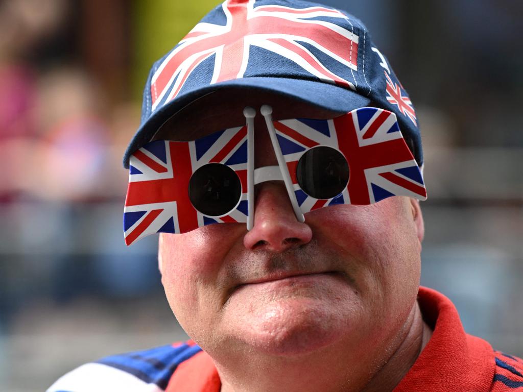 A member of the public gets creative with their glasses, shaped as the British national flag. Picture: AFP