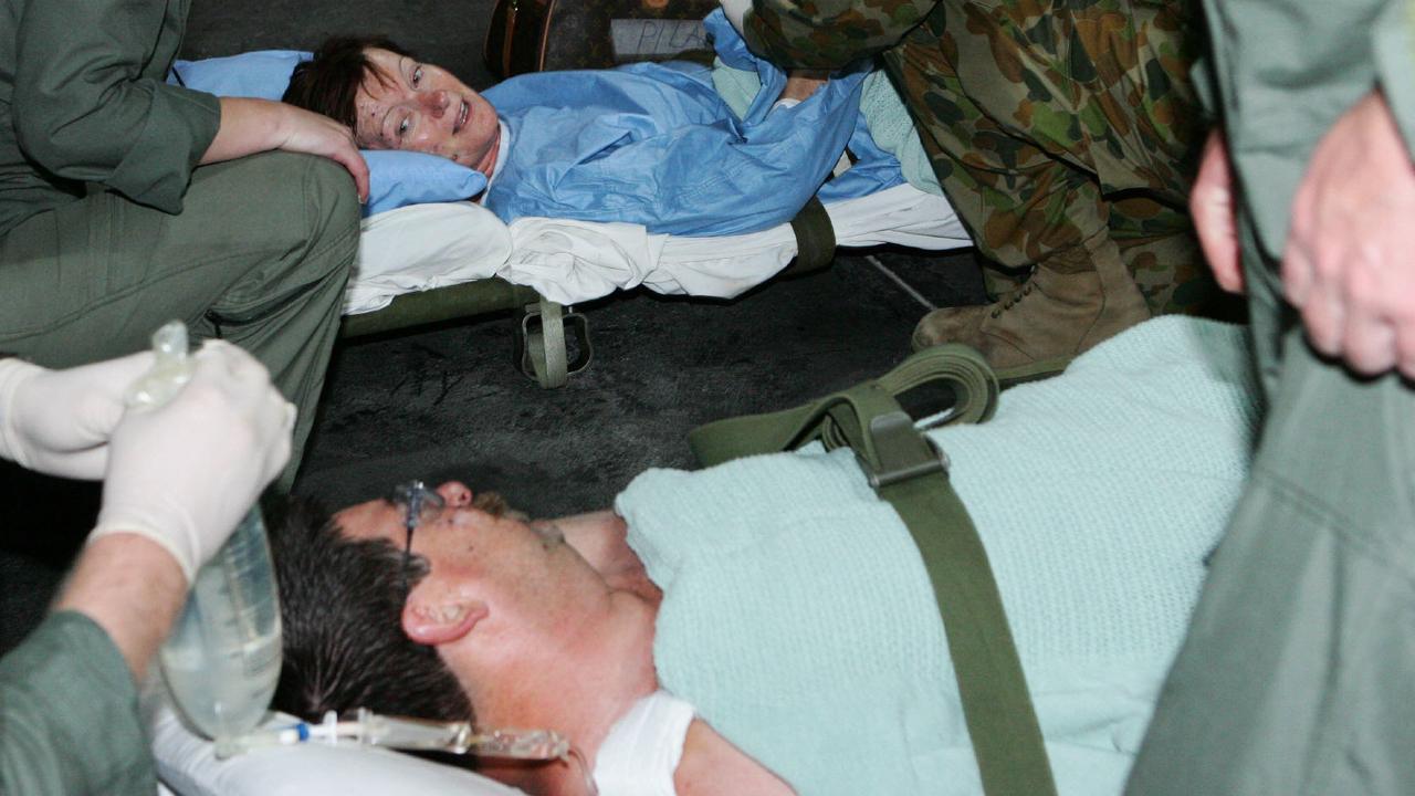 02 Oct 2005 Australian husband and wife Eric and Jenny Pilar of /Newcastle on a stretcher, both injured in Bali bomb attacks are treated by the Army. personnel before being sent back to Aust. - 3 suicide bombers killed 22 people and injured more than 100. 2 at the Menega Cafe & Nyoman's Cafe at Jimbaran Beach and the other at Raja's Restaurant & Bar in Kuta about 7pm 01 Oct. Several explosions believed to be four bombs were detonated - crime o/seas terrorism bombings Indonesia