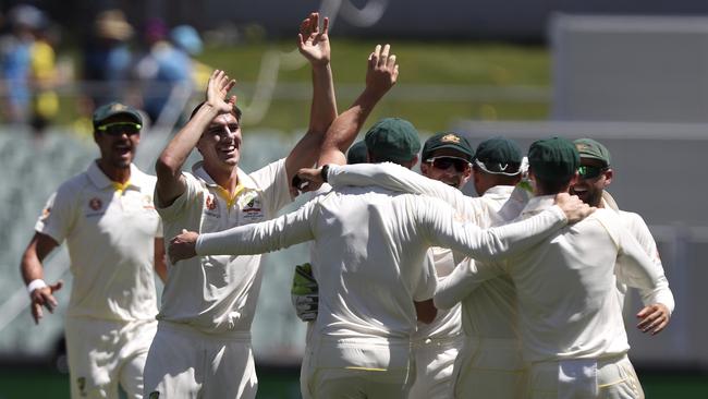 Australian players celebrate the wicket of Virat Kohli. Picture: AP