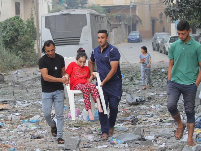 Palestinian citizens evacuate their homes damaged by Israeli airstrikes in Gaza City, Gaza. Picture: Getty Images