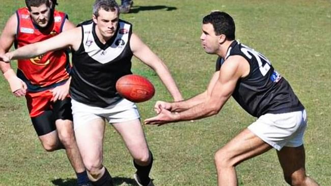 Premier Peter Malinauskas (right) handpasses in 2013 when playing for the in the premiership-winning Adelaide University Blacks Division 8R AFL team. Mr Malinauskas captained the team. Picture: Supplied