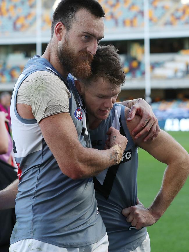 Charlie Dixon gives Gray a hug after a game at the Gabba this year.