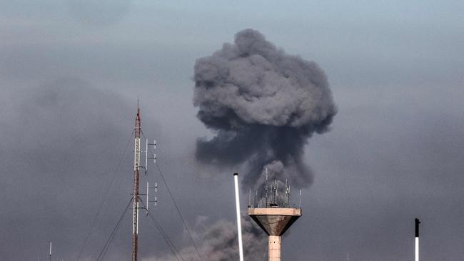 This picture taken from Rafah shows smoke rising over buildings in Khan Younis during Israeli bombardment. Picture: AFP