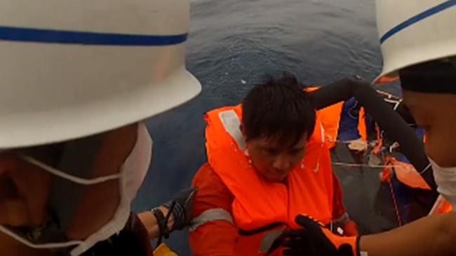 A man is rescued from a life raft by the Japanese coastguard after the Gulf Livestock 1, which was carrying 6,000 cows, issued a distress call early September 2 as Typhoon Maysak passed through the area. Picture: AFP