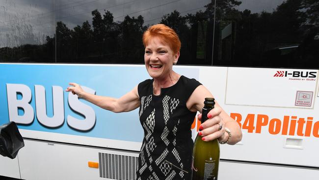 One Nation leader Pauline Hanson pops a bottle of  sparkling  wine before boarding her Battler Bus in Brisbane yesterday. Picture: Dave Hunt/AAP